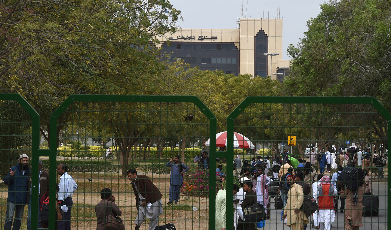 Pakistani passengers gather outside the Jinnah International Airport as they wait for flight operations to resume in Karachi on March 1, 2019. (AFP/File)