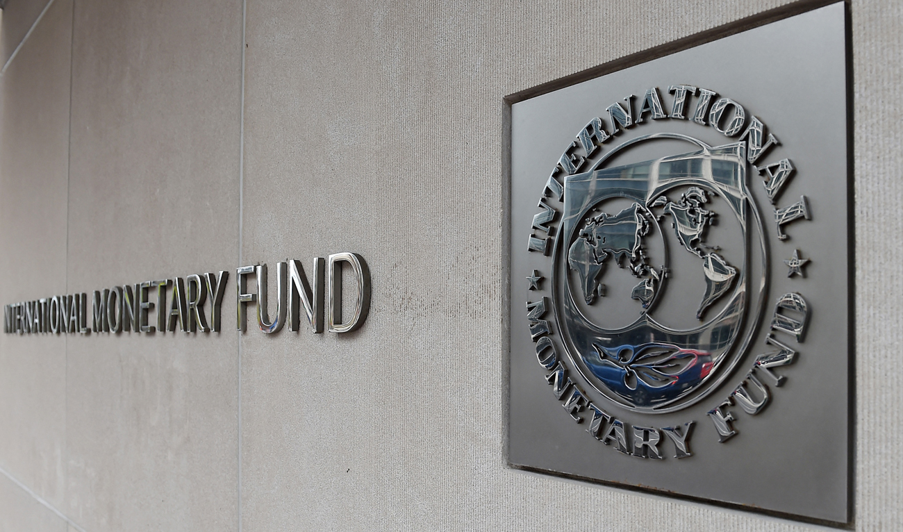 An exterior view of the building of the International Monetary Fund (IMF), with the IMG logo, is seen on March 27, 2020 in Washington, DC. (AFP/File)