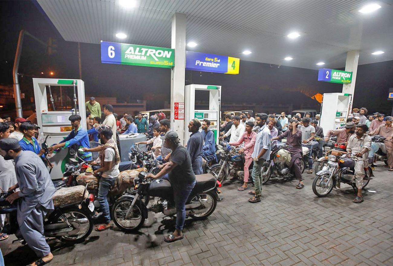 People wait their turn to get fuel at a petrol station, in Karachi, Pakistan on June 2, 2022. (REUTERS)