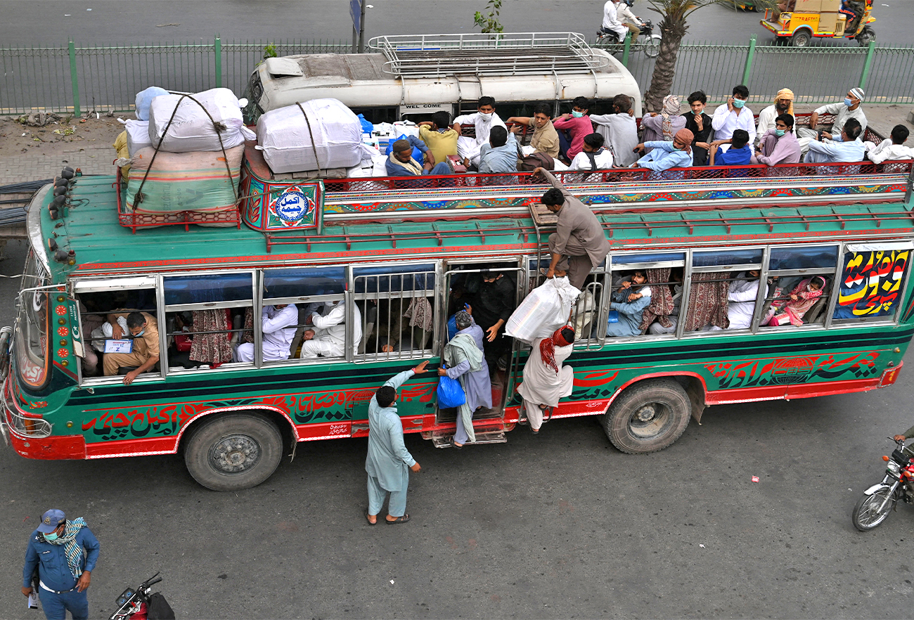 Muslims travel in an overcrowded bus in Lahore, Pakistan, on May 7, 2021. (AFP/File)