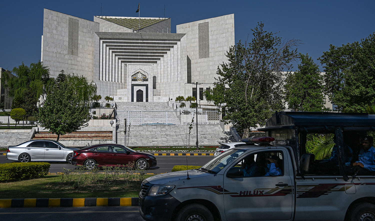Motorists drive past Pakistan's Supreme Court in Islamabad on April 5, 2022. (AFP/File)