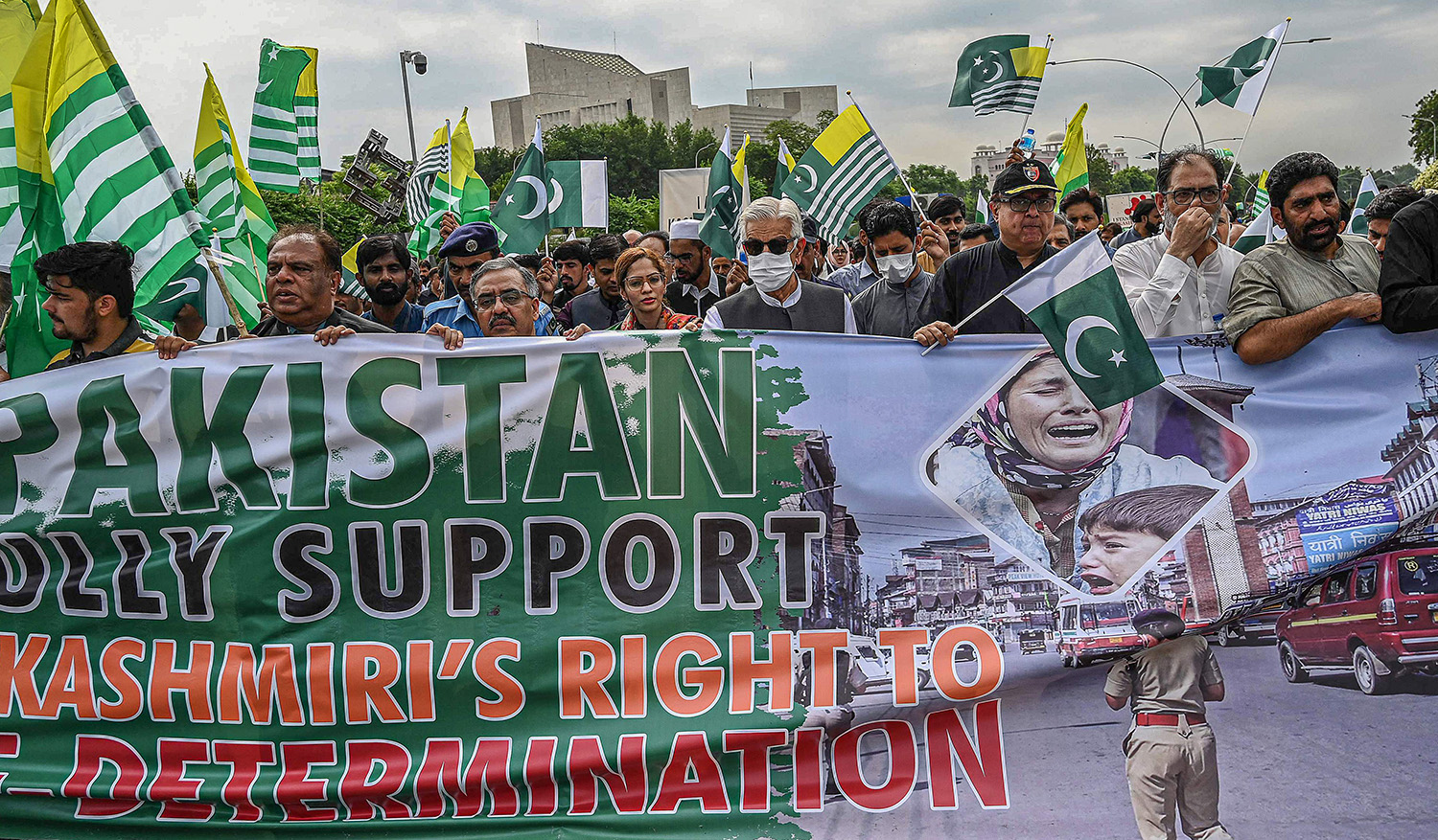 Demonstrators hold a banner and placards during a protest to show their solidarity with people of Indian-administered Kashmir, in Islamabad on August 5, 2022. (AFP)