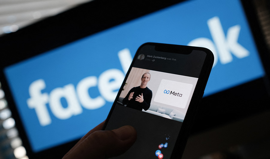 In this illustration photo taken in Los Angeles on October 28, 2021, a person watches on a smartphone Facebook CEO Mark Zuckerberg unveil the META logo. (AFP/FILE)