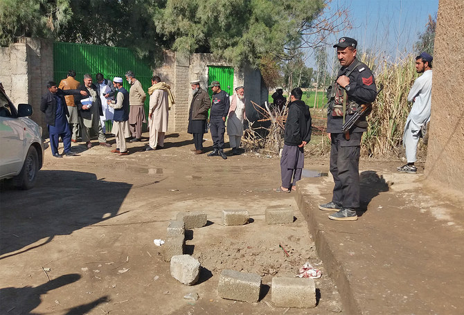 In this file photo, Police officials gather at the site of an attack by gunmen in Kohat, some 75 kms southwest of Peshawar, Pakistan, on January 25, 2022. (AFP/FILE)