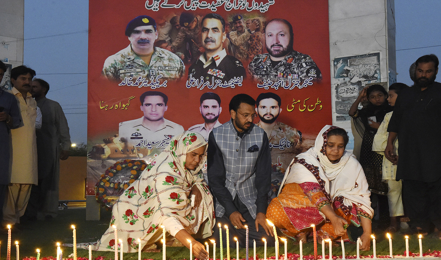 Residents light candles to pay tribute to Pakistan's servicemen, who lost their lives in a helicopter crash, in Quetta on August 3, 2022. (AFP)