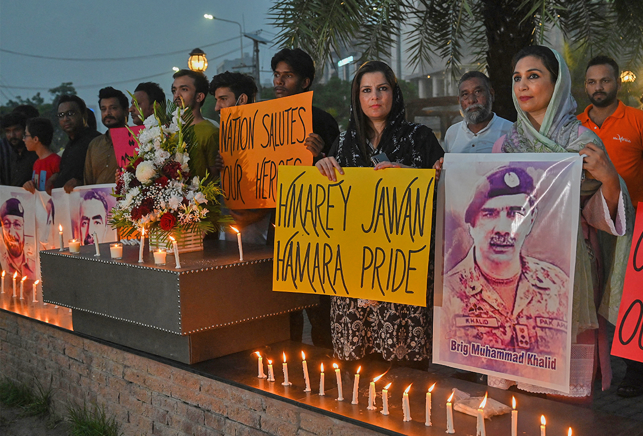 Activists pay tribute to six Pakistani servicemen, who died in a helicopter crash during flood relief operations, in Lahore, Pakistan, on August 6, 2022. (AFP)