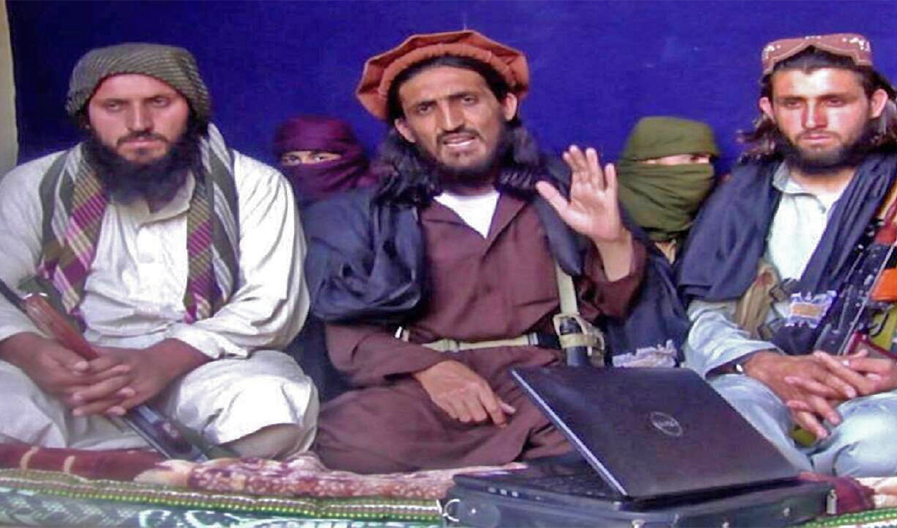In this file image, Omar Khalid Khorasani (C), a top Pakistan Taliban commander, gives an interview in Pakistan's Mohmand tribal region on June 2, 2011. (REUTERS)