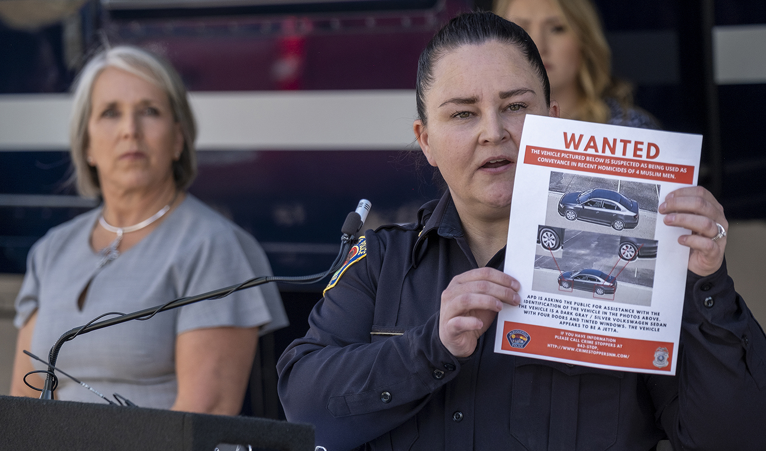 Albuquerque Police Deputy Chief of Investigations Cecily Barker holds a flyer with photos of a car wanted in connection with Muslim men murdered in Albuquerque, New Mexico, on August 7, 2022. (Albuquerque Journal via AP)