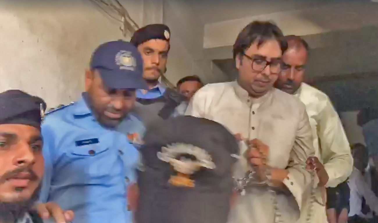 The screengrab taken from the video shot by Abdullah Jan of Independent Urdu shows handcuffed PTI leader, Shahbaz Gill, being taken to a court in Islamabad, Pakistan, on Aug 10, 2022. (Independent Urdu)