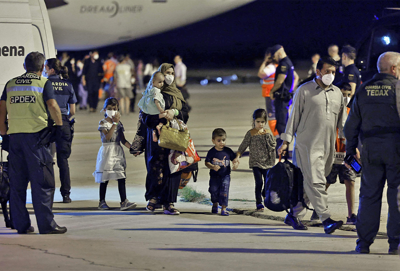 Family members of Afghans who collaborated in Afghanistan with the Spanish authorities arrive from Islamabad in an airplane chartered by Spain, at the Torrejón de Ardoz military air base, Spain, on August 10, 2022. (AFP)