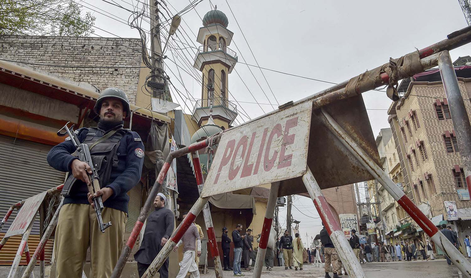 Policeman stand guard outside a mosque in Peshawar, Pakistan on March 5, 2022. (AFP/File)