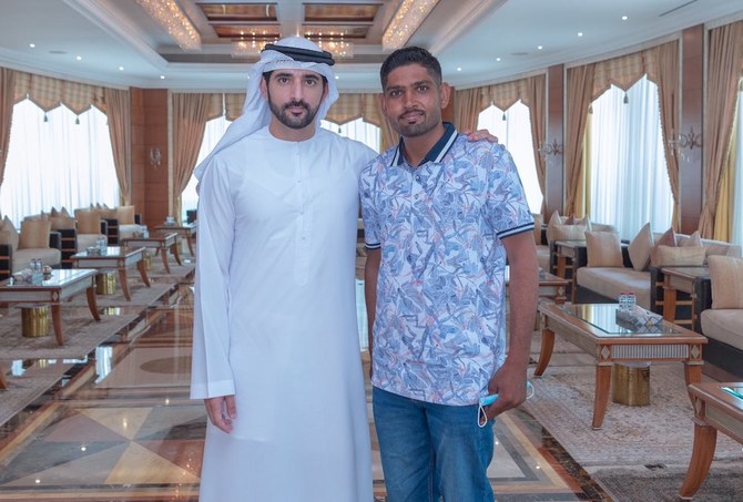 Above, Dubai’s Crown Prince Sheikh Hamdan bin Mohammed bin Rashid Al-Maktoum with delivery rider Abdul Ghafoor Abdul Hakeem. (Twitter: @HamdanMohammed)