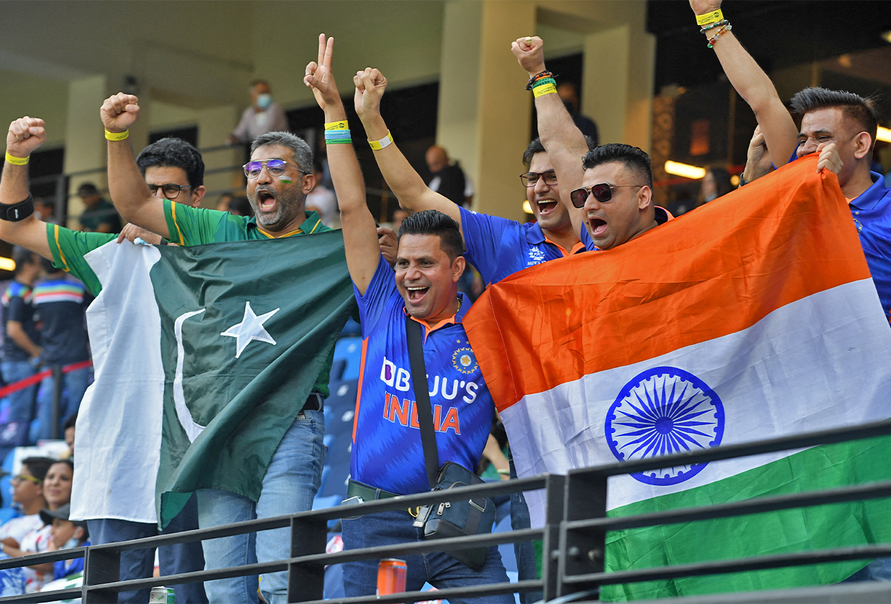 In this file photo taken on October 24, 2021, fans of Pakistan's and Indian cricket teams cheer before the start of the ICC men’s T20 World Cup cricket match between India and Pakistan in Dubai. (AFP/File)
