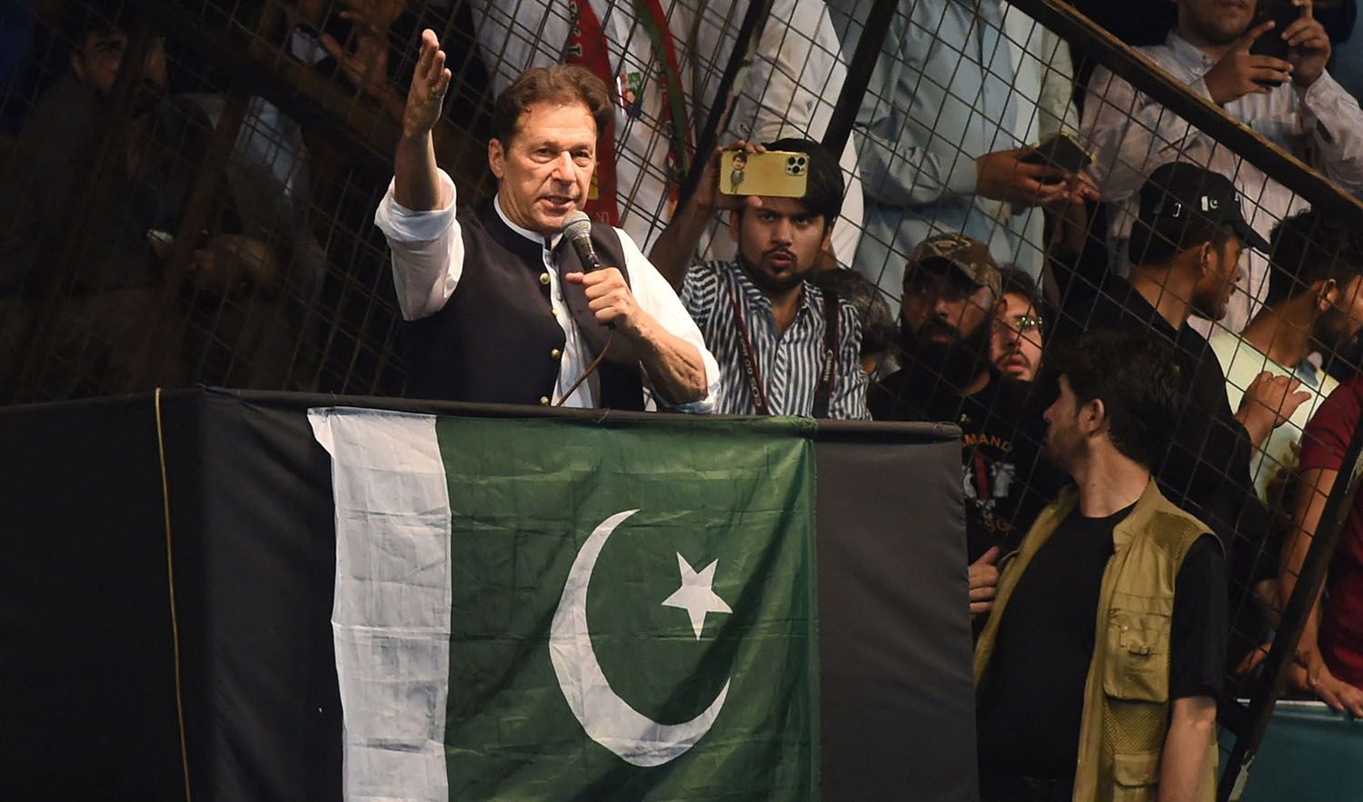 Pakistan's former Prime Minister and Pakistan Tehreek-e-Insaf party (PTI) chief Imran Khan, delivers a speech to his supporters during a rally celebrate the 75th anniversary of Pakistan's independence day in Lahore on August 13, 2022. (AFP)