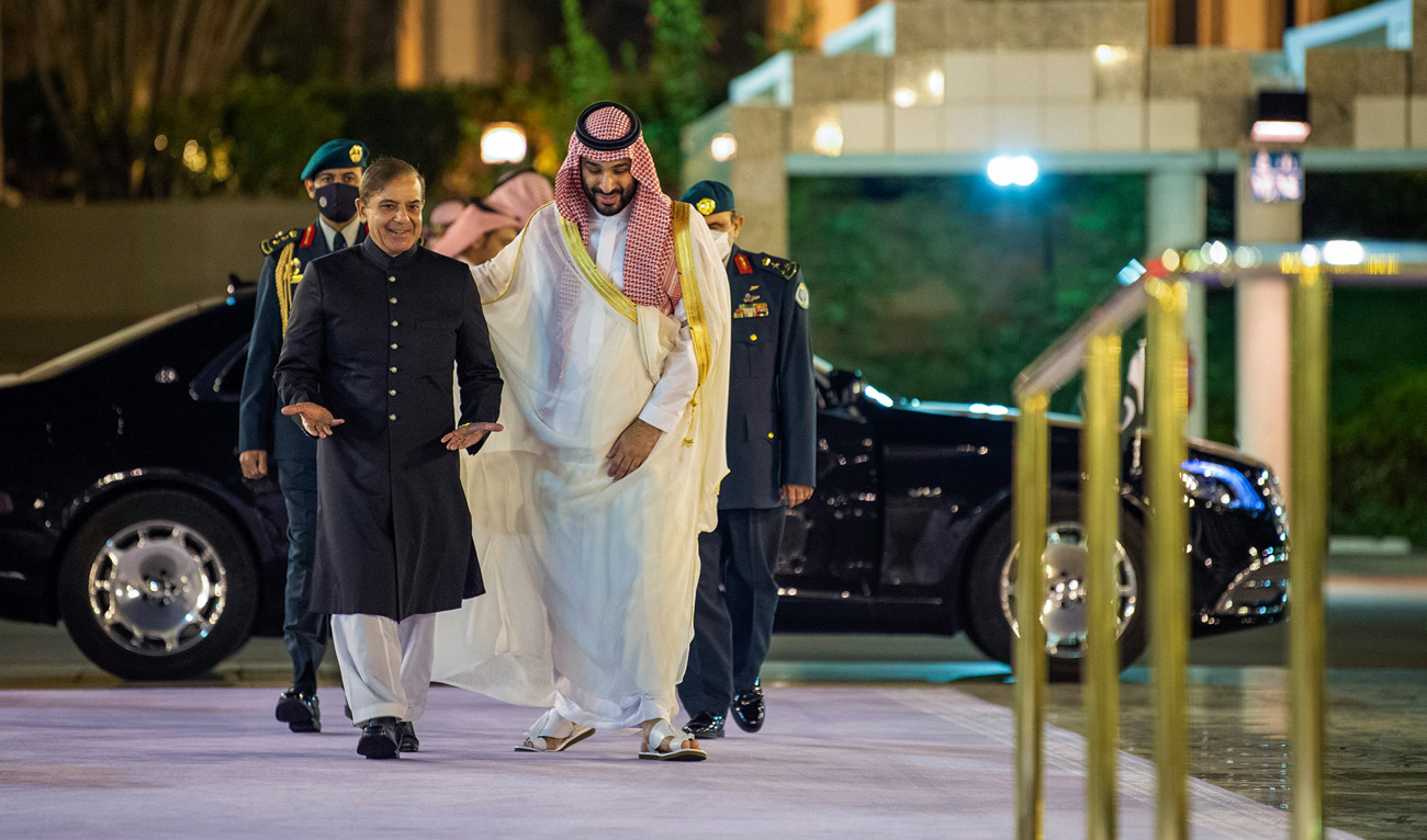 A handout picture provided by the Saudi Royal Palace shows Saudi Arabia's Crown Prince Mohammed Bin Salman (R) welcoming Pakistani Prime Minister Shehbaz Sharif in Jeddah on April 30, 2022. (AFP/File)
