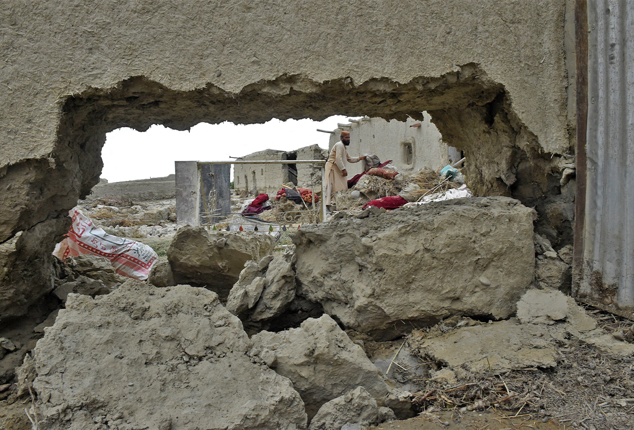 Flood affected residents clear debris after the dam in Pishin district of Balochistan, Pakistan, broke due to heavy rains on July 7, 2022. (AFP)