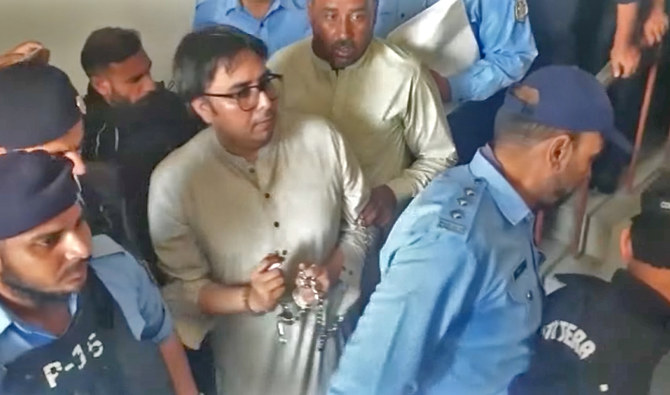 The screen grab from a video shared on YouTube shows Islamabad Police escorting PTI leader, Shahbaz Gill (handcuffed), after a court hearing in Islamabad, Pakistan, on August 11, 2022. (Shahbaz Gill/Youtube)