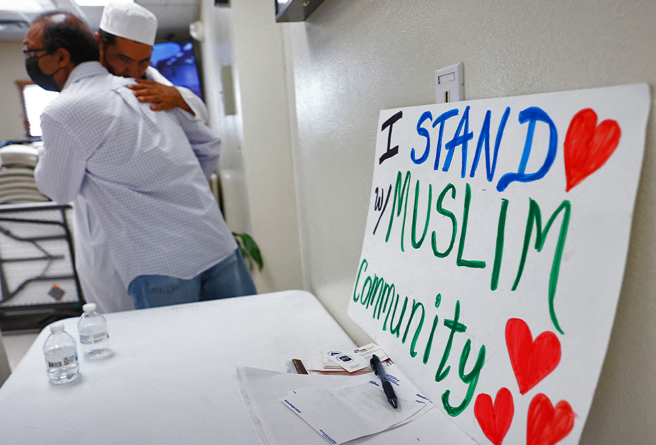 Muslims embrace following Friday prayers at the Islamic Center of New Mexico on August 12, 2022 in Albuquerque, New Mexico. (AFP)