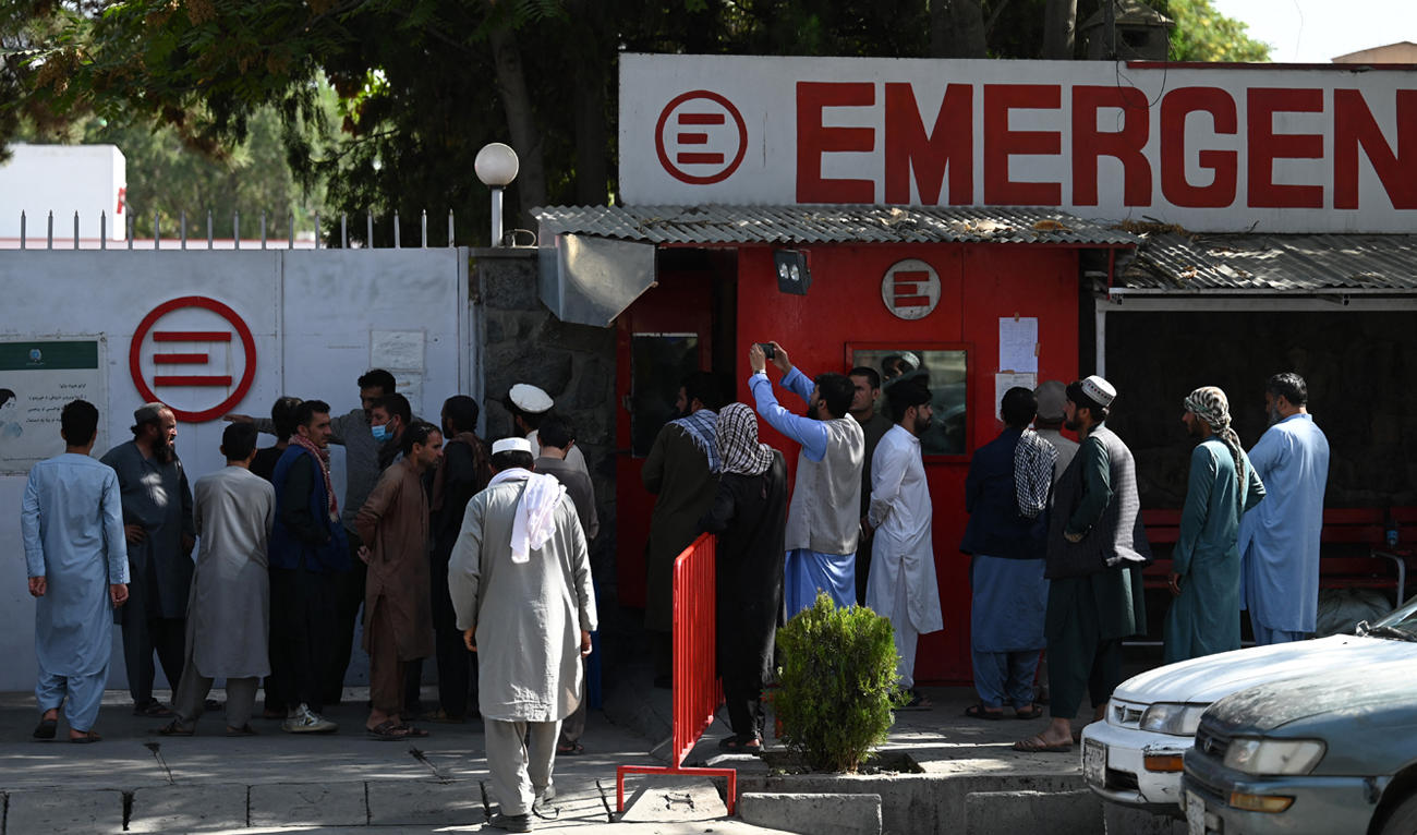 People gather to check on missing relatives a day after a twin suicide bombs attack, which killed scores of people including 13 US troops outside Kabul airport, at a hospital run by Italian NGO Emergency in Kabul on August 27, 2021. (AFP/File)