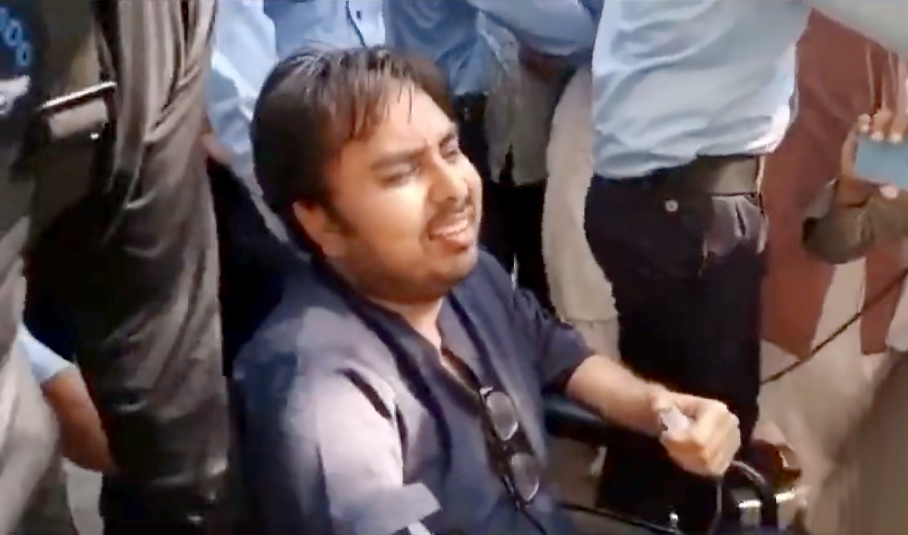 The screengrab taken from PTI's Twitter account shows Islamabad police escorting Shahbaz Gill to prison van after a court hearing in Islamabad, Pakistan, on August 19, 2022. (PTI/Twitter)