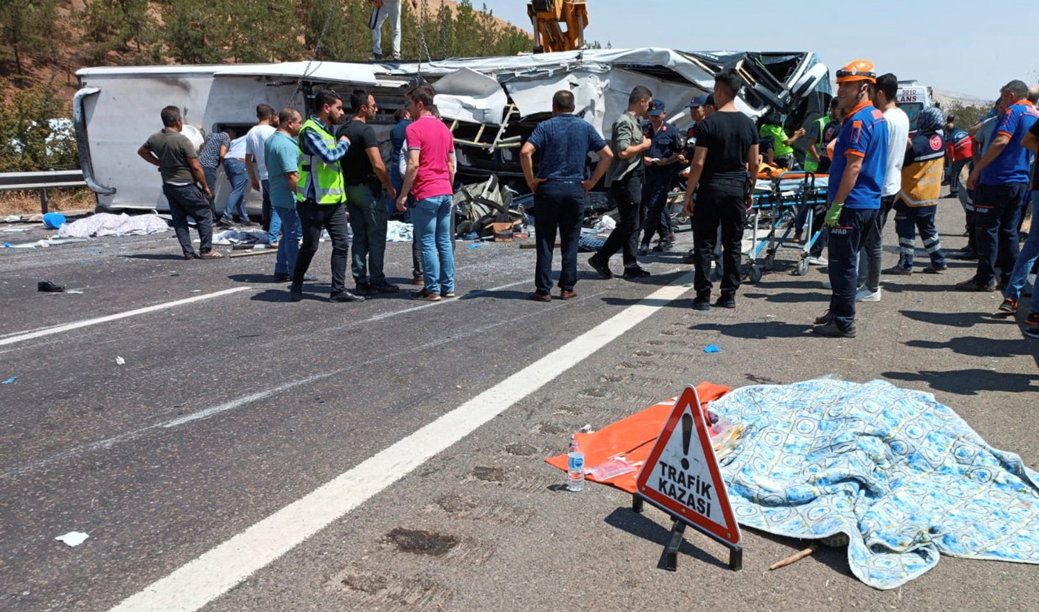 Rescue and emergency responders work at the scene after a bus crash on the highway between Gaziantep and Nizip, Turkey on August 20, 2022. (Ihlas News Agency via REUTERS)