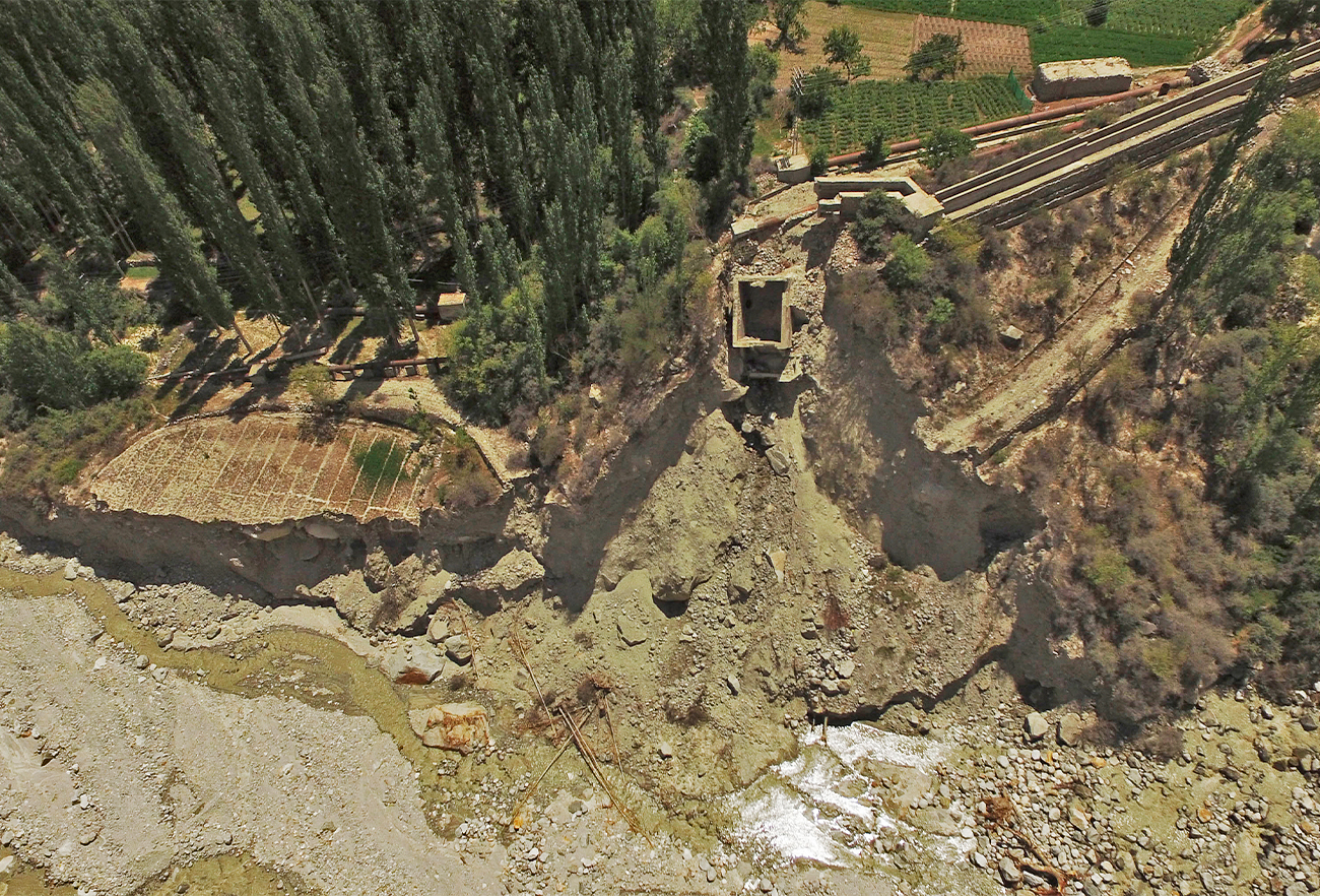 This aerial picture taken on June 9, 2022, shows the remains of two electrical power stations that were swept away by a lake outburst because of a melting glacier, in Hassanabad village of Pakistan's Gilgit-Baltistan region. (AFP)