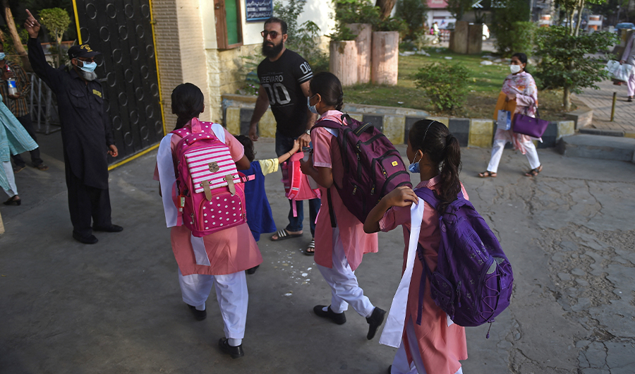 Students prepare to enter their school in Karachi on August 30, 2021. (AFP/FILE)