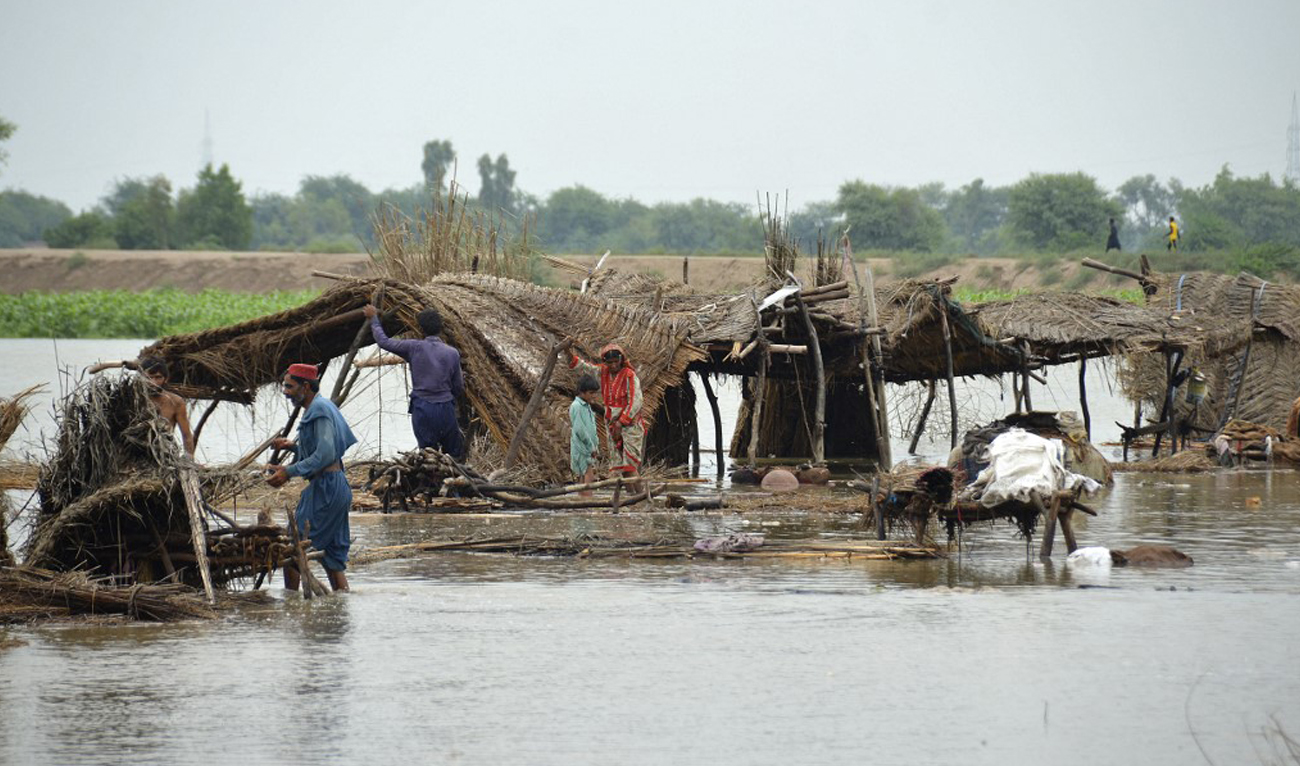Villagers search for their belongings after their huts were destroyed in flood waters in Jaffarabad district of Balochistan province on August 22, 2022. (AFP)