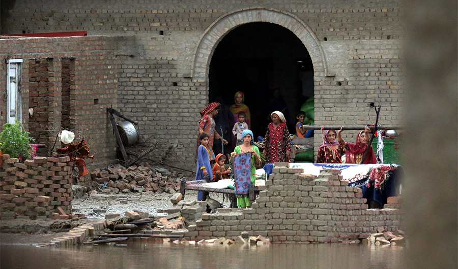 Women and children are stranded after deadly floods in Maula Bux Shar village in Larkana, Pakistan on August 25, 2022. (AN Photo/S.A. Babar)