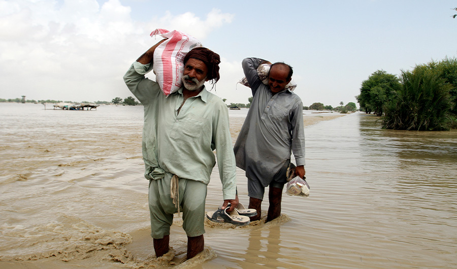 Pakistani men receive food, distribute by Pakistani Army troops in a flood-hit area in Rajanpur, district of Punjab, Pakistan, Saturday, Aug. 27, 2022. (AP)