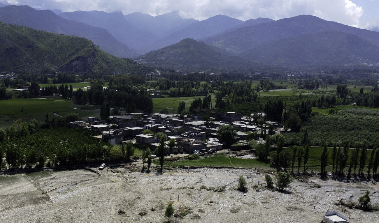 An aerial view shows the flooded land following heavy monsoon rains in Mingora, a town in Pakistan's northern Swat valley on August 28, 2022. (AFP)