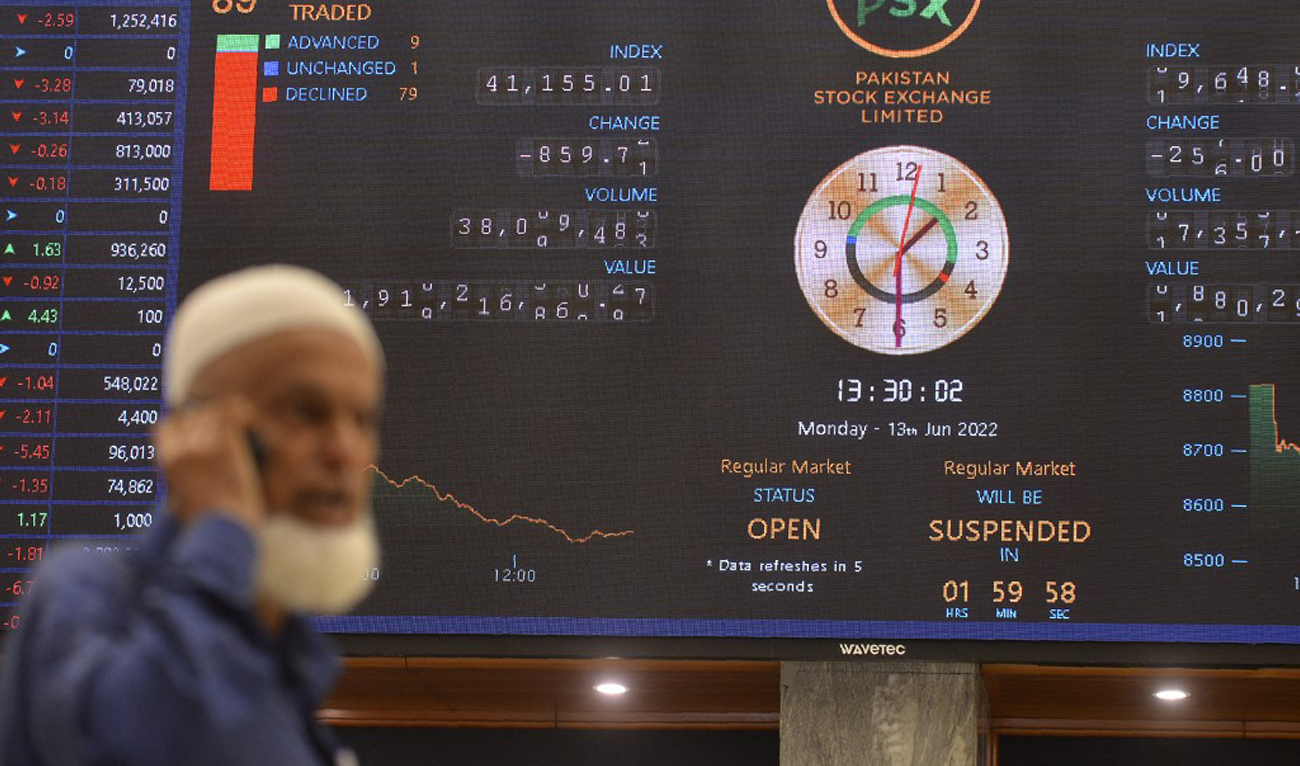 A stockbroker monitors the latest share prices during a trading session at the Pakistan Stock Exchange (PSX) in Karachi on June 13, 2022. (AFP/File)