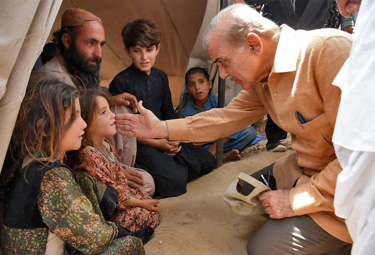 Pakistan Prime Minister Shehbaz Sharif (R) visits the flood relief camps in Balochistan’s Qila Saifullah district on August 1, 2022. (Government of Pakistan)
