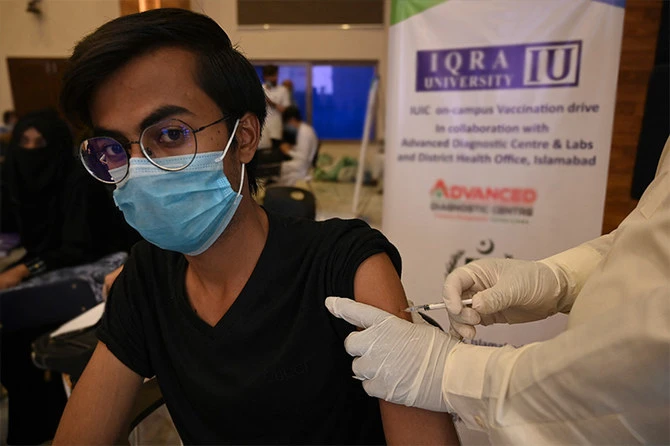 A student receives a dose of the CanSino Biologics' Covid-19 coronavirus vaccine at a university in Islamabad on June 28, 2021. (AFP)