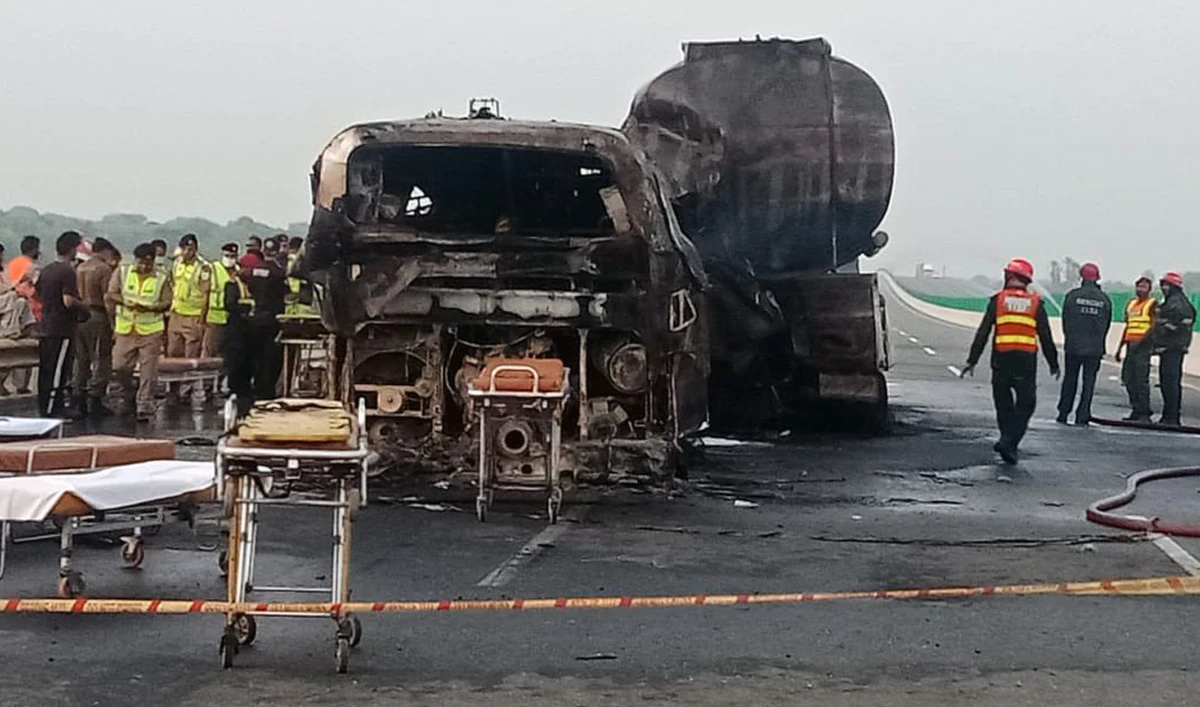 This handout photo shows the charred passenger bus and oil tanker following the collision on the Multan-Sukkur Motorway in central Pakistan on August 16, 2022. (Twitter/Commissioner Multan)