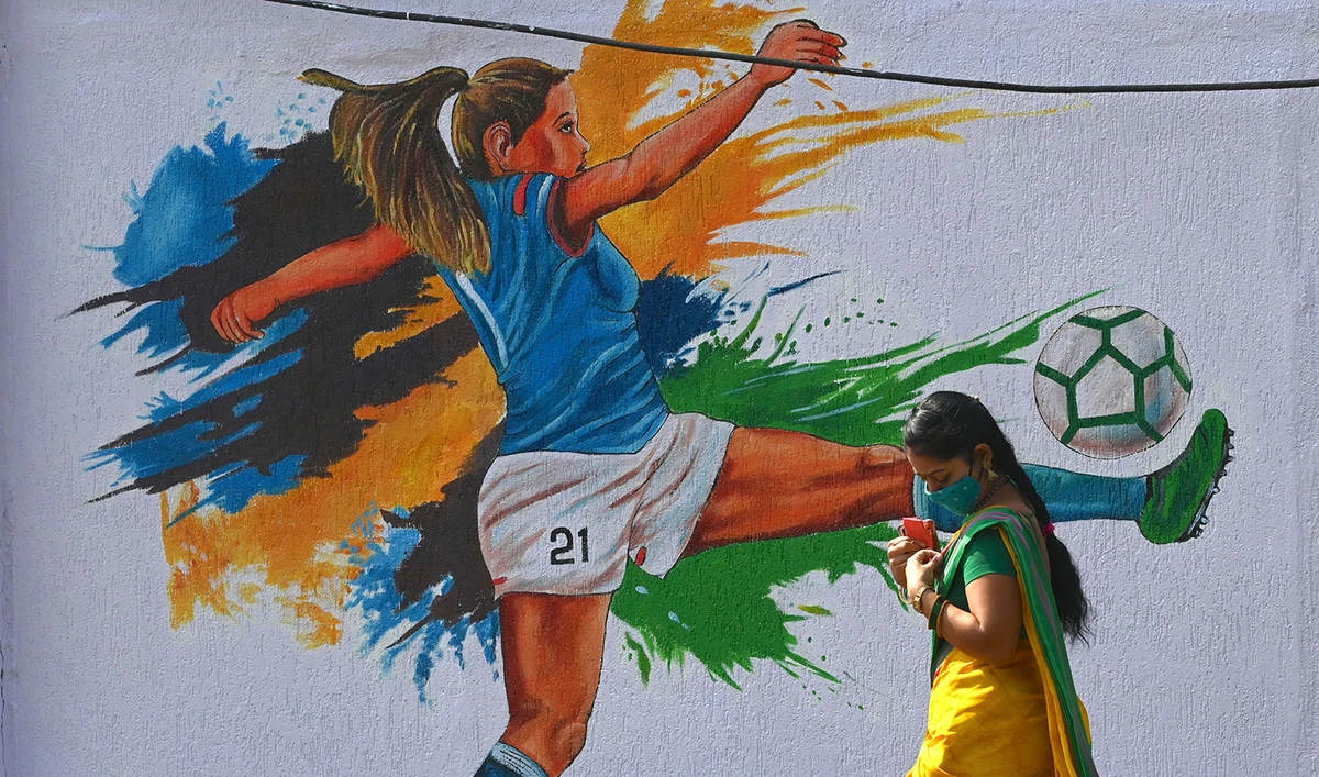 A woman walks past a women’s football wall mural ahead of the Asian Football Confederation (AFC) Women's Asian Cup India 2022 Finals at Vashi in Navi Mumbai on January 16, 2022. (AFP/File)