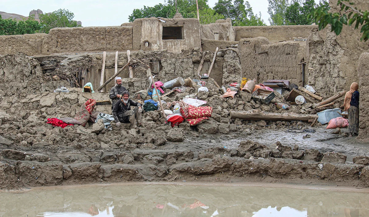 People collect their belongings from their damaged homes after heavy flooding in the Khushi district of Logar province south of Kabul, Afghanistan, on August 21, 2022. (AP)