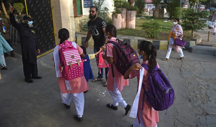 Students prepare to enter their school in Karachi on August 30, 2021. (AFP/FILE)