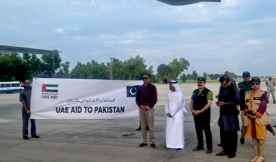 Pakistan's Planning Minister Ahsan Iqbal (2nd from L) and UAE envoy to Pakistan Hamad Obaid Al-Zaabi (3rd from L) standing near UAE aid aircraft (not pictured) in Islamabad on Aug 29, 2022. (Twitter/@PlanComPakistan)