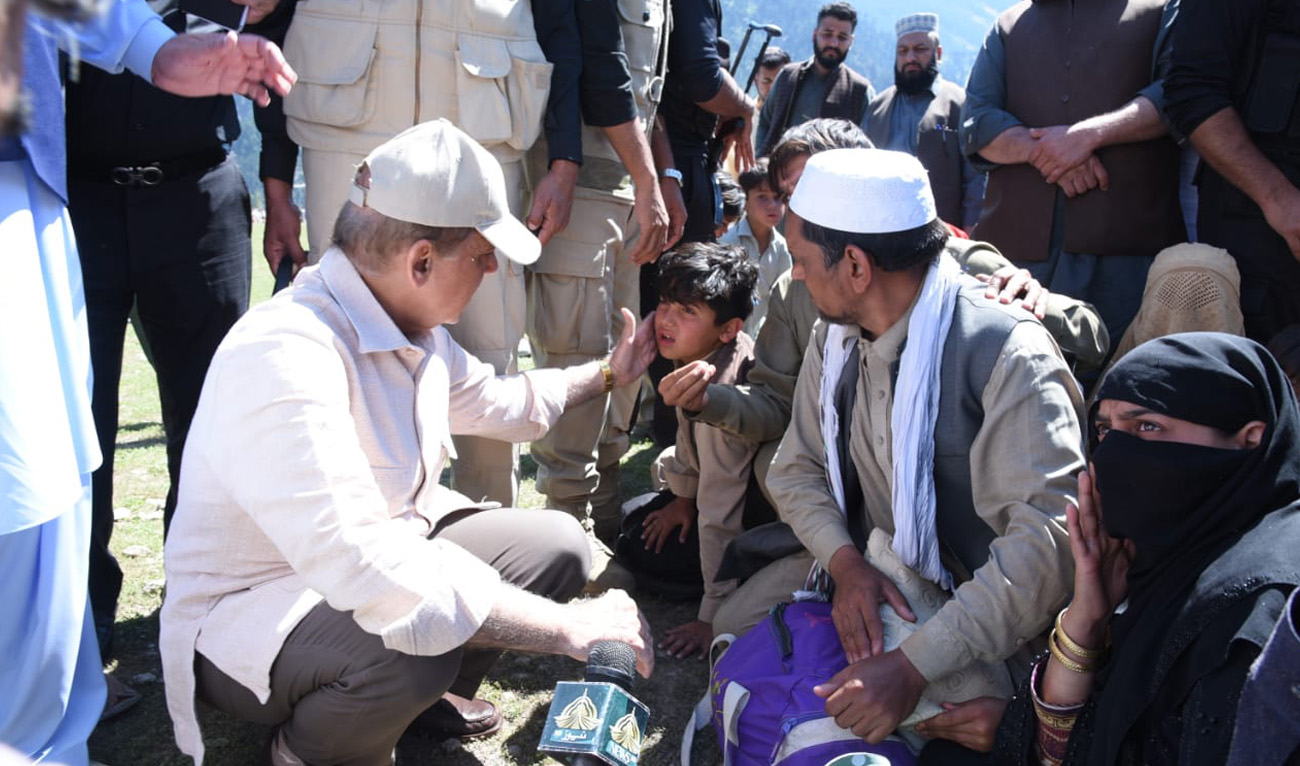This handout picture was taken on August 31, 2022, during Pakistan Prime Minister Shehbaz Sharif's visit to flood-hit Kalam where he reviewed the relief operation and met affectees. (Government of Pakistan)