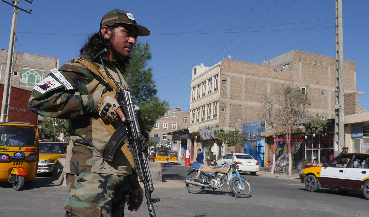 A Taliban fighter stands guard along a road after a blast during the Friday prayer in Gazargah mosque, in Herat, Afghanistan, on September 2, 2022. (AFP)