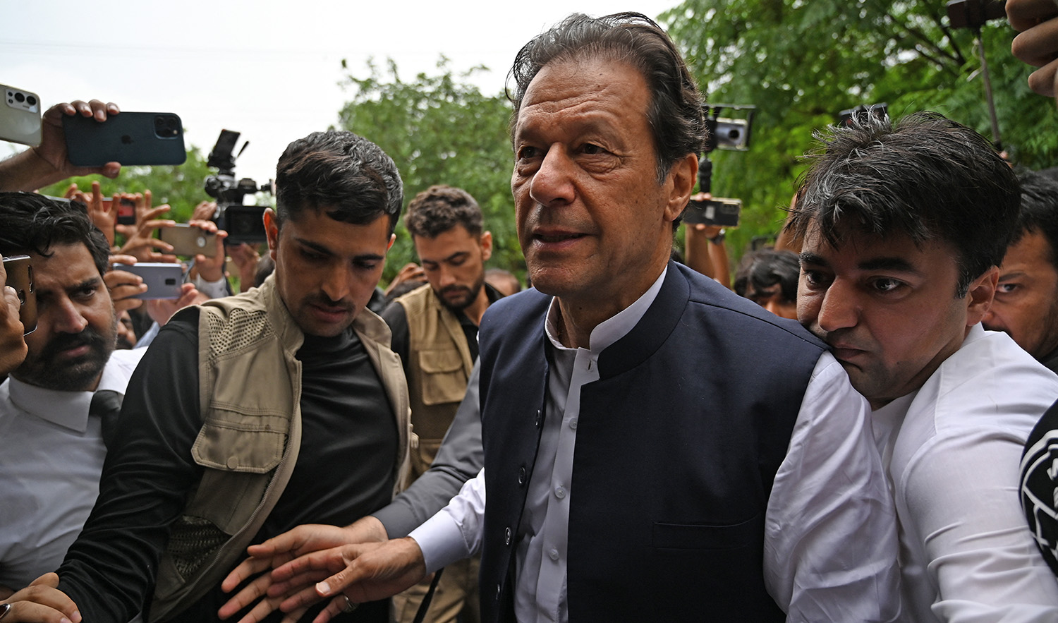 Former Pakistani prime minister Imran Khan, center, arrives to appear before the an anti-terrorism court in Islamabad on August 25, 2022. (AFP/File)