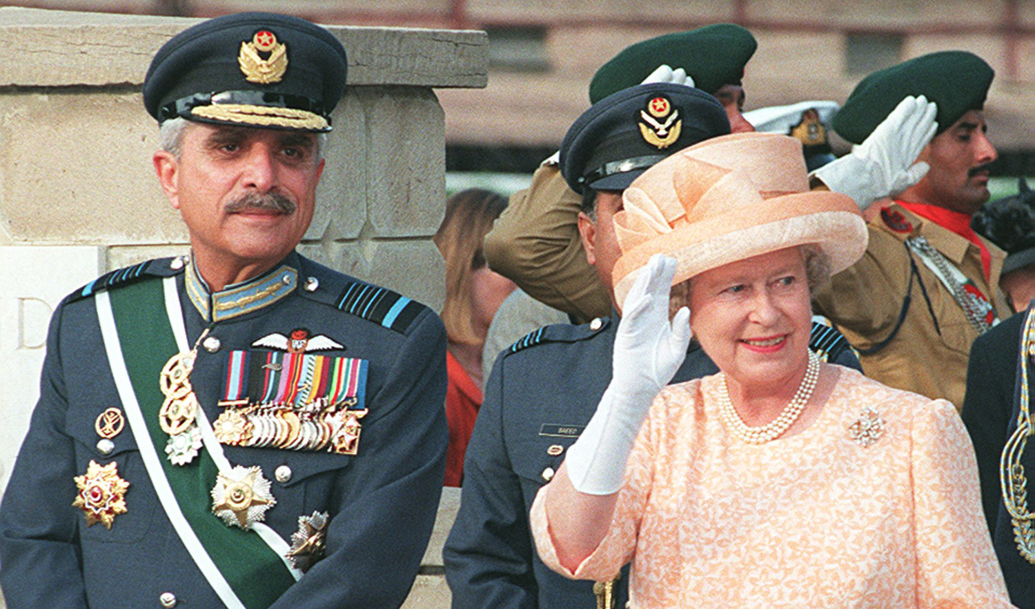 Britain's Queen Elizabeth ll, right, along with Farooq Feroze Khan, Chairman Joint Chief of Staffs of Pakistans forces, waves to the people outside the Commonwealth War Graves Cemetery in Rawalpindi on October 8, 1997. (AFP/File)