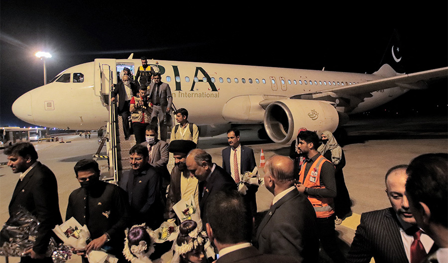Passengers disembark off a Pakistan International Airlines Airbus A320 aircraft after landing on the tarmac at Najaf International Airport which serves Iraq's central holy shrine city on October 30, 2021. (AFP/FILE)