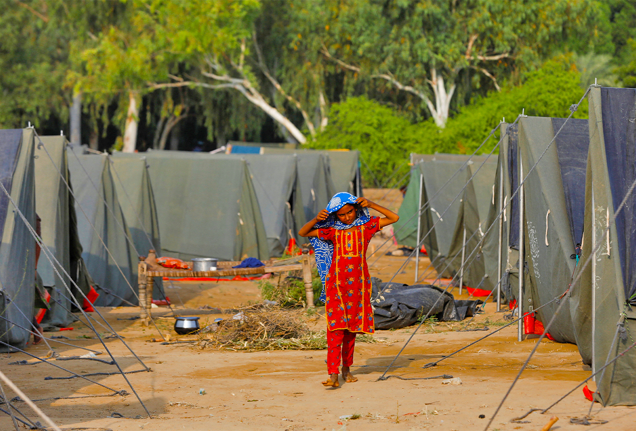A girl whose family became displaced walks amid tents, following rains and floods during the monsoon season in Sehwan, Pakistan, on September 13, 2022. (REUTERS)