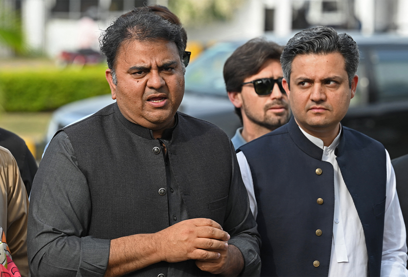 Leader of the Pakistan Tehreek-e-Insaf (PTI) party, Fawad Chaudary (L), speaks to the media outside the parliament house building in Islamabad on April 11, 2022. (AFP/File)