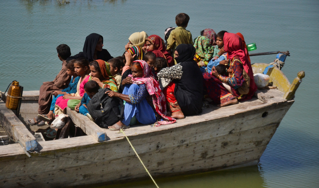 People, displaced because of the floods, travel on a boat as they head back to their village, following rains and floods during the monsoon season in Sehwan, Pakistan September 20, 2022. (REUTERS)