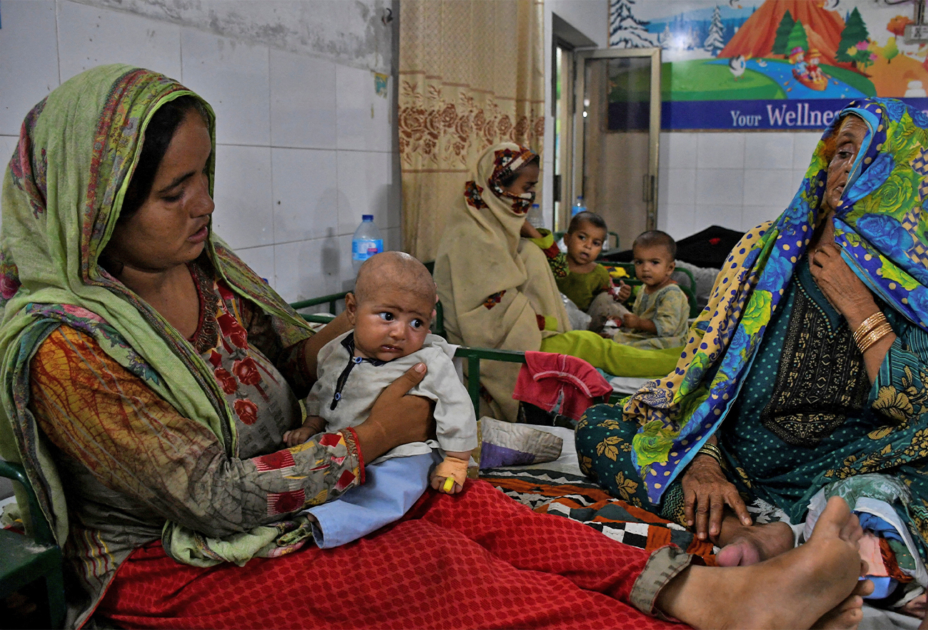 Women displaced because of the floods, take care of their ailing babies at a hospital, following rains and floods during the monsoon season in Jamshoro, Pakistan, on September 20, 2022. (REUTERS)