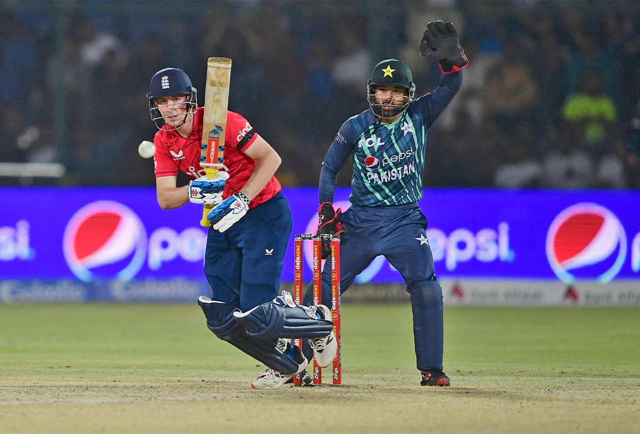 England's Harry Brook (L) plays a shot during the first Twenty20 international cricket match between Pakistan and England at the National Cricket Stadium in Karachi on September 20, 2022. (AFP)