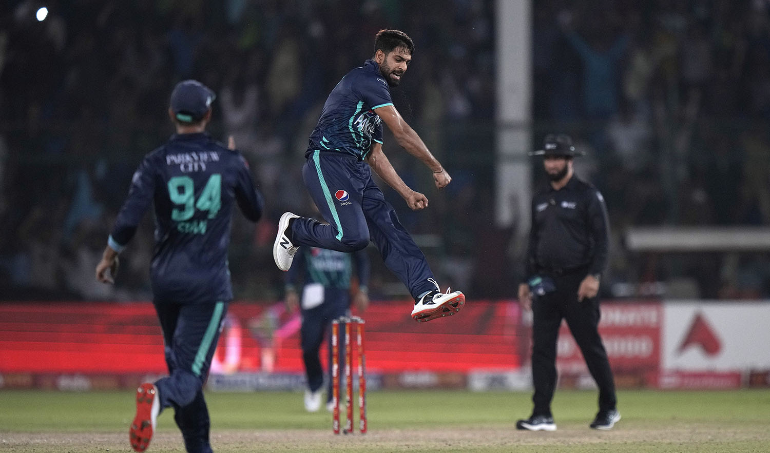Pakistan's Harif Rauf, center, jumps to celebrate after taking the wicket of England's Olly Stone during the fourth twenty20 cricket match between Pakistan and England, in Karachi, Pakistan, on September 25, 2022. (AP)